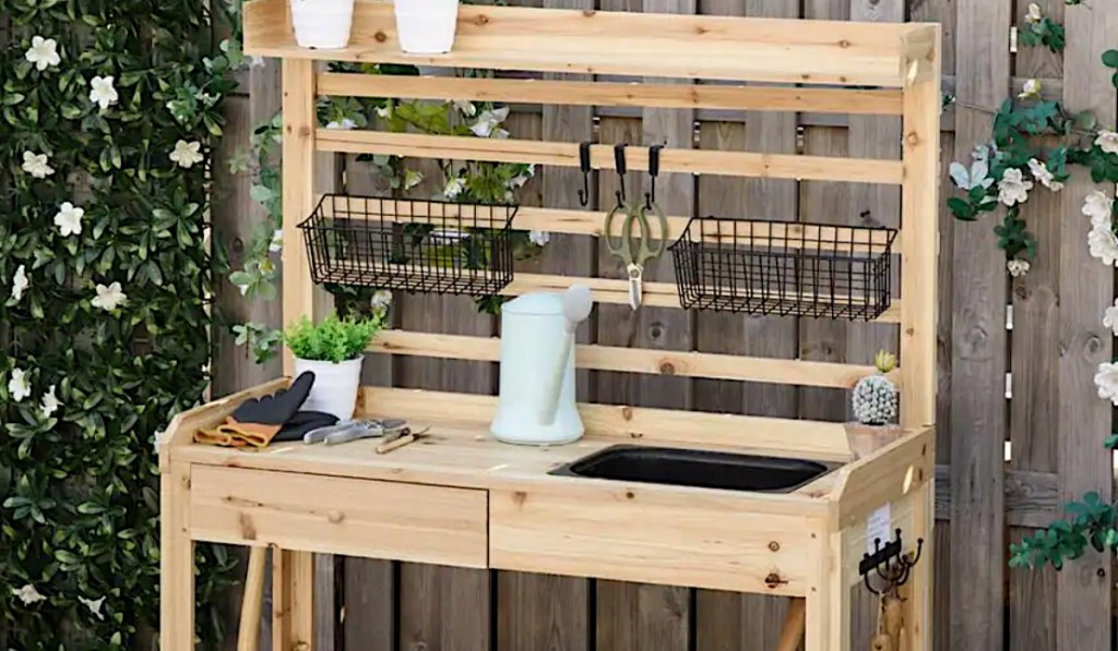 Expert Gardener Potting Bench in backyard with gardening supplies