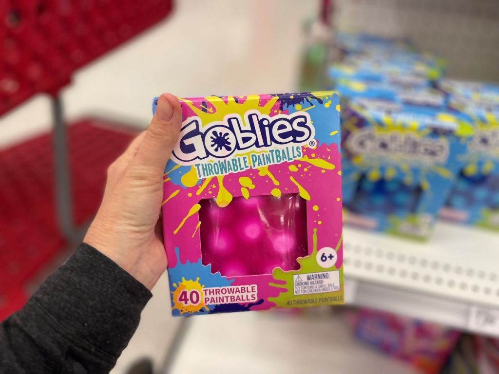 Hand holding a pack of Goblies Throwable Paintballs