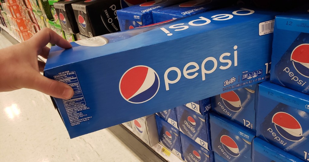 Ergreift mit der Hand eine Pepsi-12er-Packung aus dem Regal