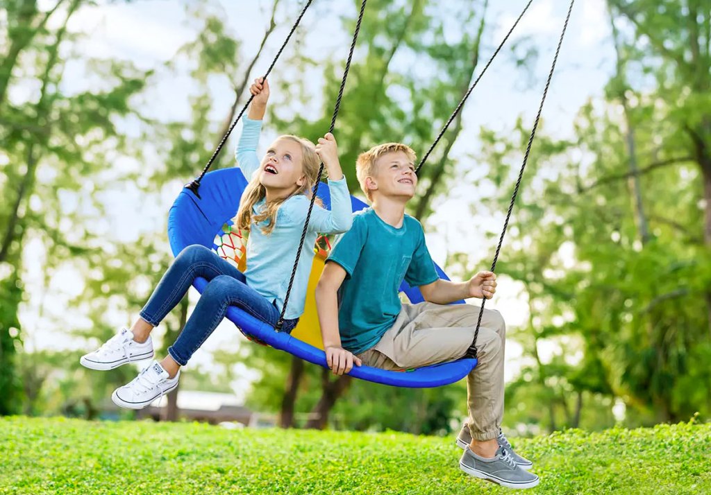 two kids on swing
