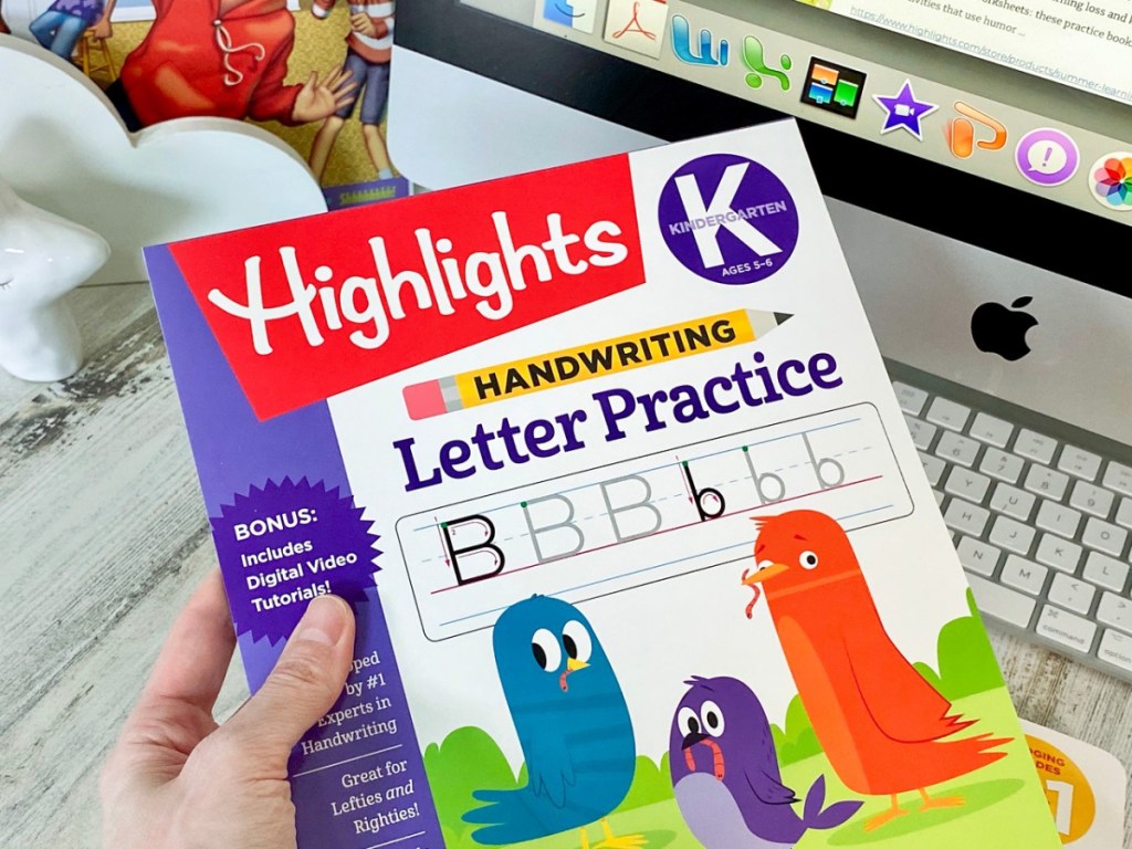 hand holding Highlights Letter Practice Book