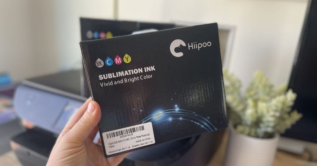 hand holding Hipoo Sublimation Ink Refills box