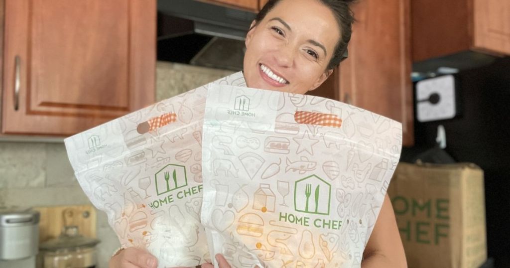 woman holding two Home Chef bags