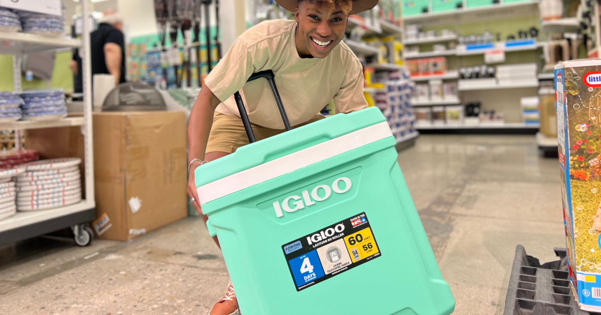woman holding large roller cooler in store