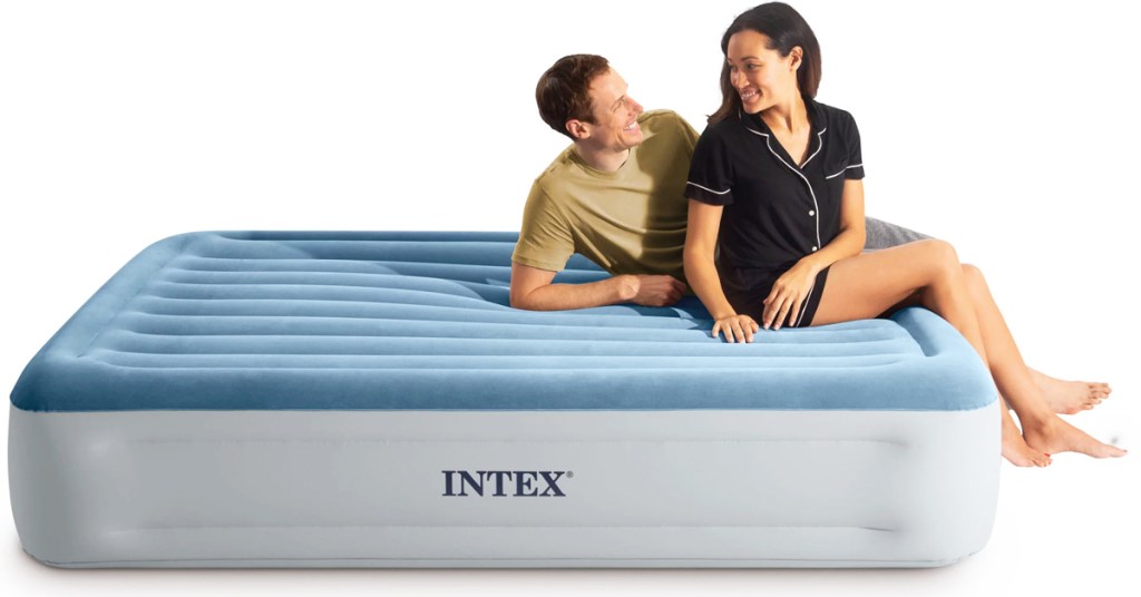two people sitting on air mattress