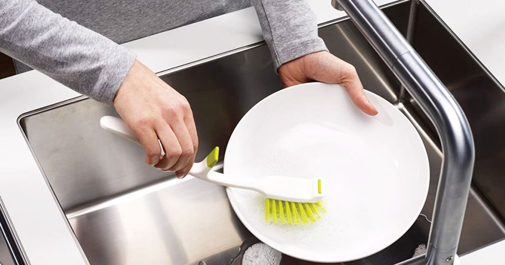 using dish brush on a dinner plate