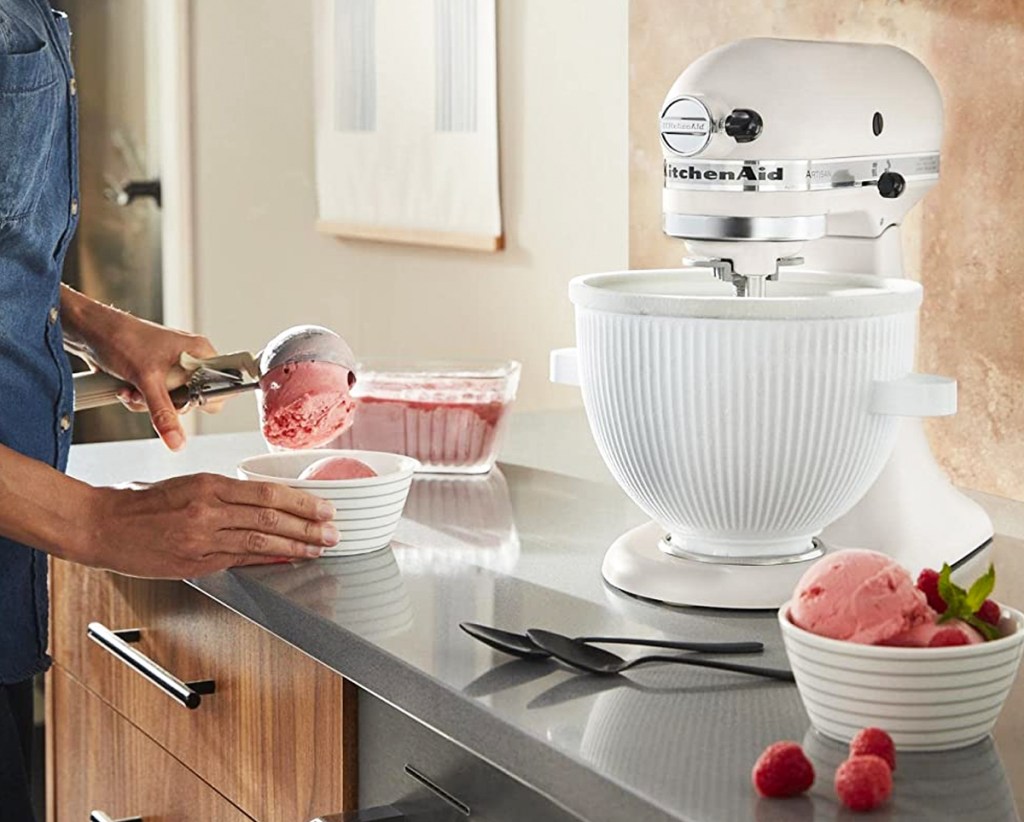 scooping strawberry ice cream from a kitchenaid ice cream attachment
