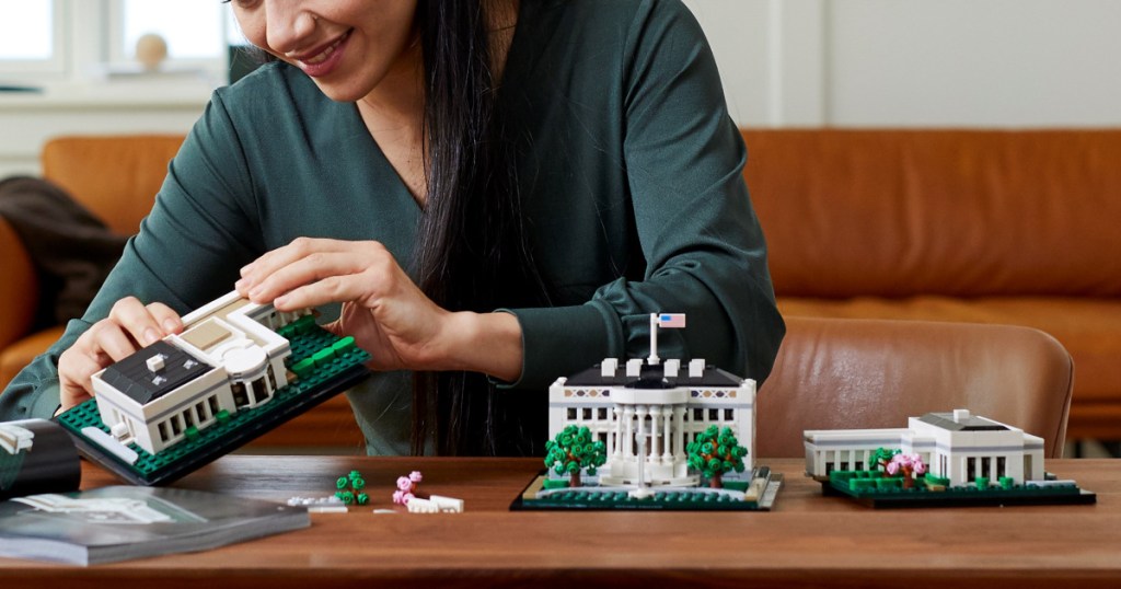 woman building LEGO The White House Building Set