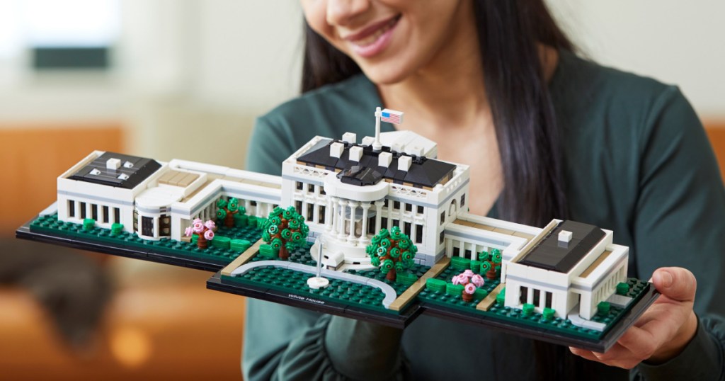 woman holding a completed LEGO The White House Building Set