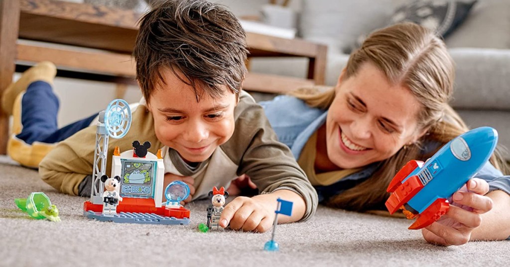 kid and mom playing with legos