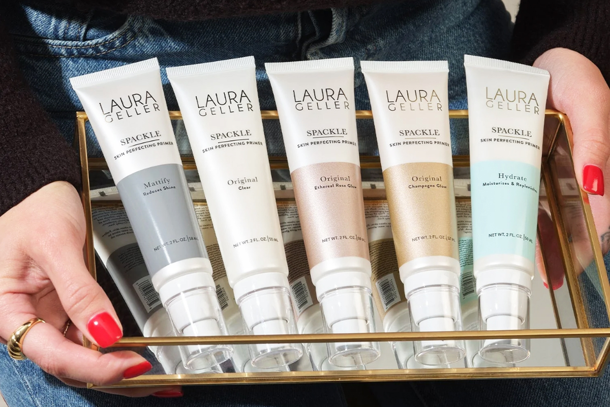 woman holding tray of laura geller primers