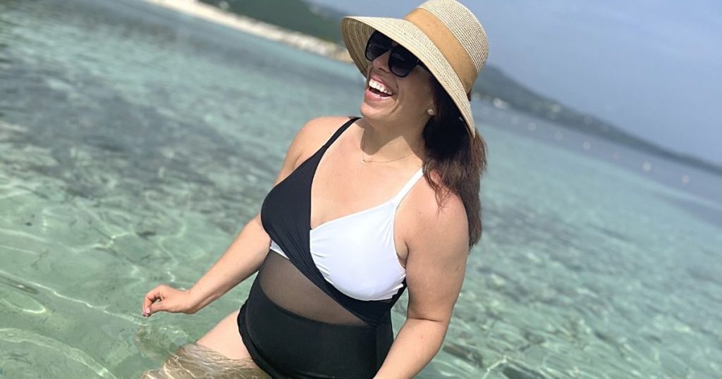 woman wearing black and white wrap swimsuit in water