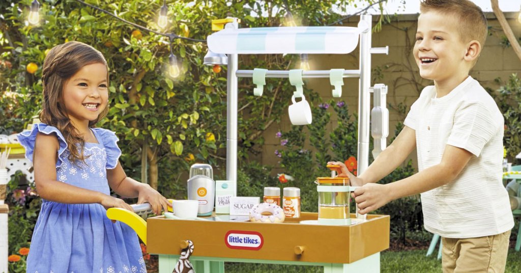 two kids playing with little tikes cafe cart