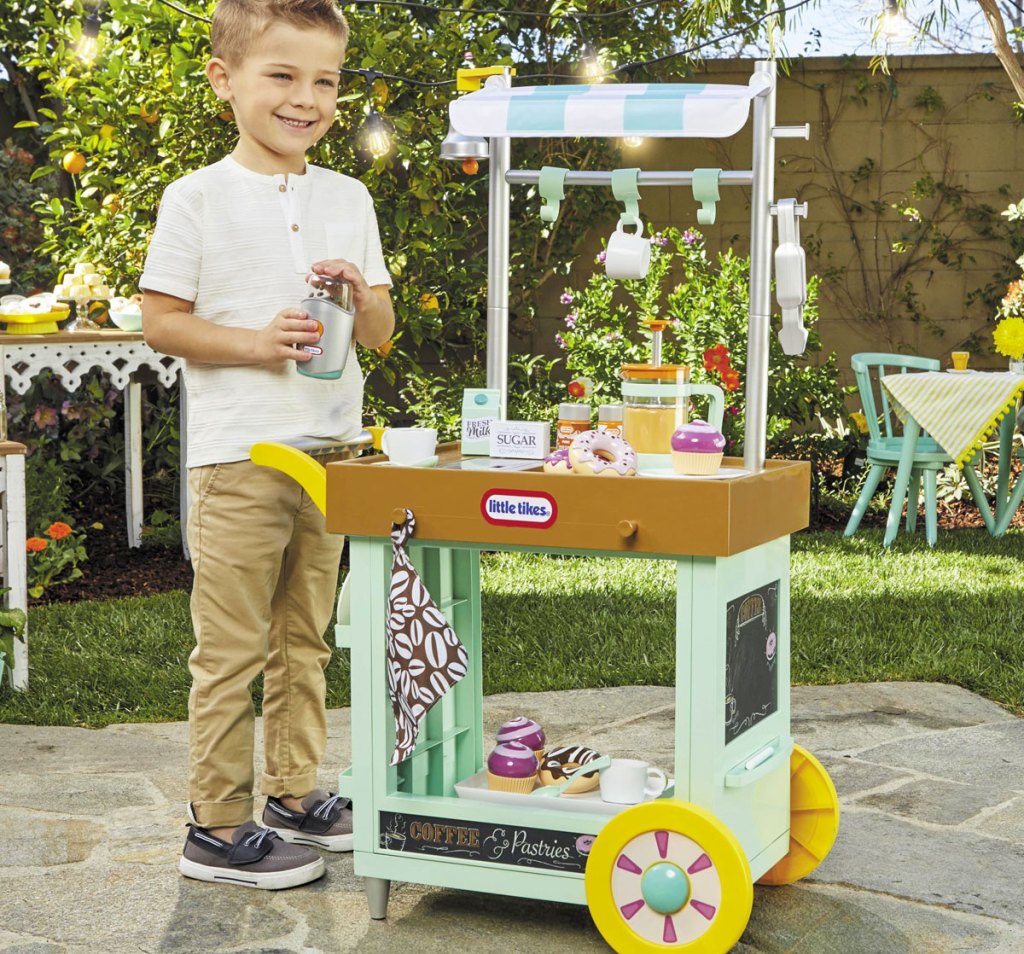 boy playing with little tikes cafe cart