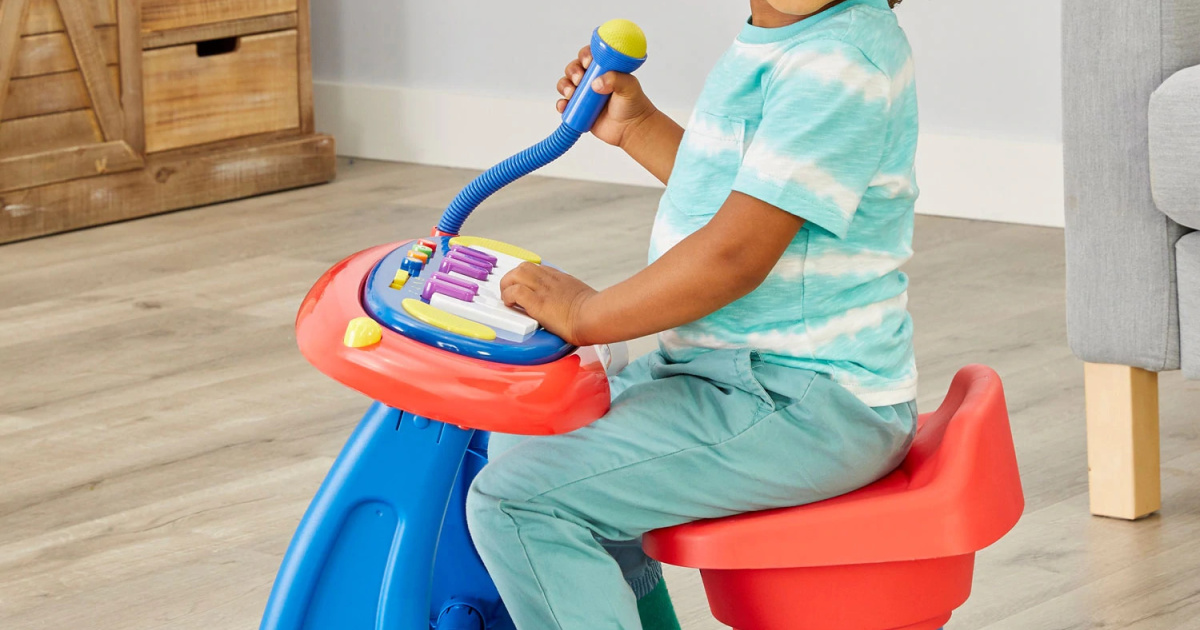 boy sitting at interactive sing-along piano