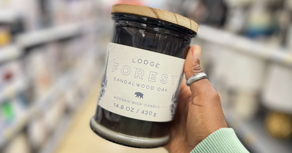 Hand holding Lodge Forest Candle at Walmart
