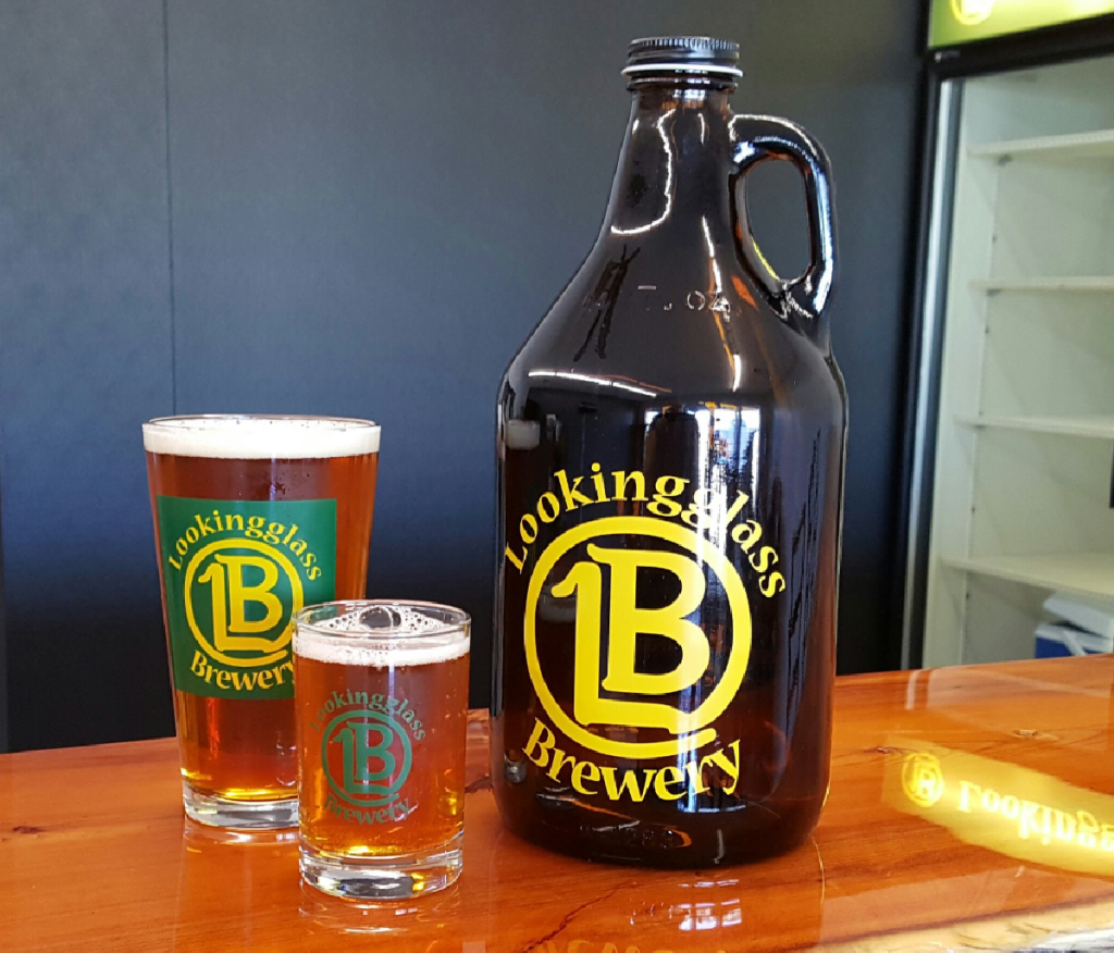 A growler and pint glasses from Looking Glass Brewery in Dewitt, Michigan