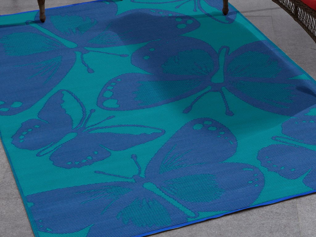 Blue rug with dark blue butterflies printed on it