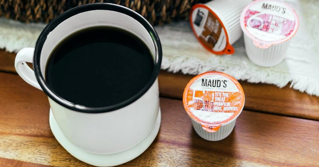 Maud's Coffee K-Cup next to mug of coffee on table