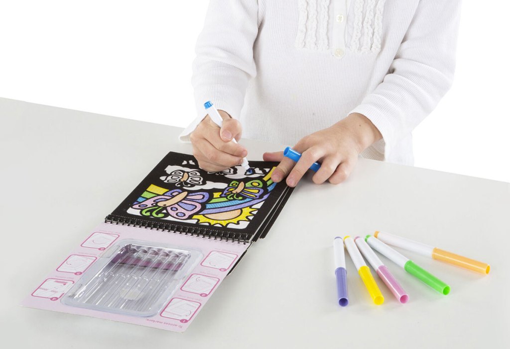 girl coloring in velvet coloring pad