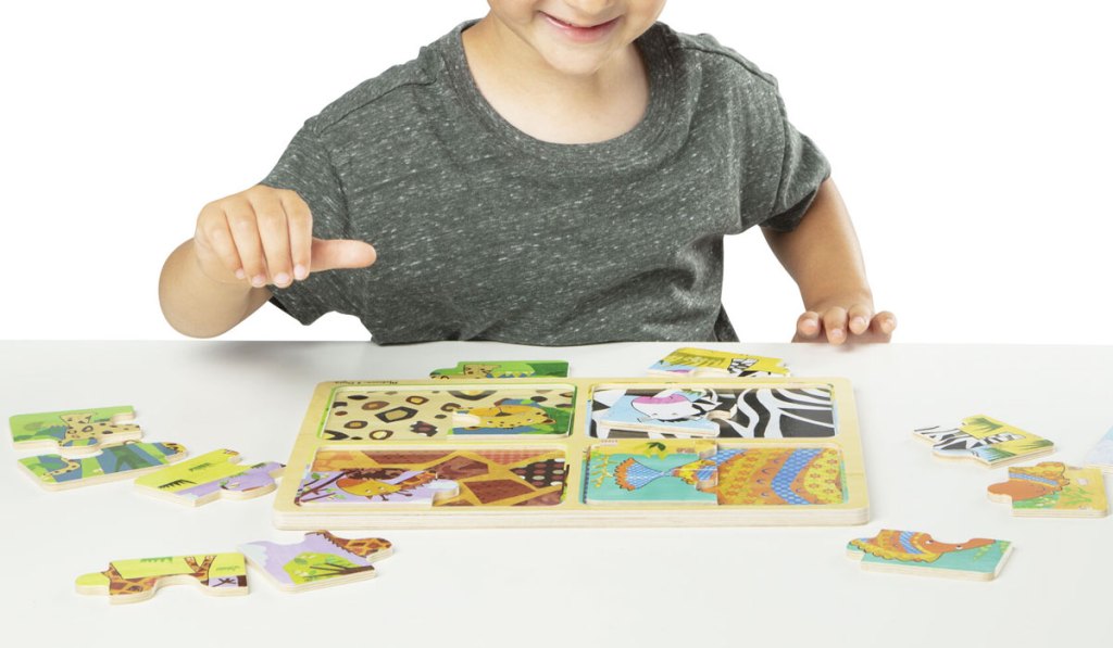 boy playing with wooden puzzle
