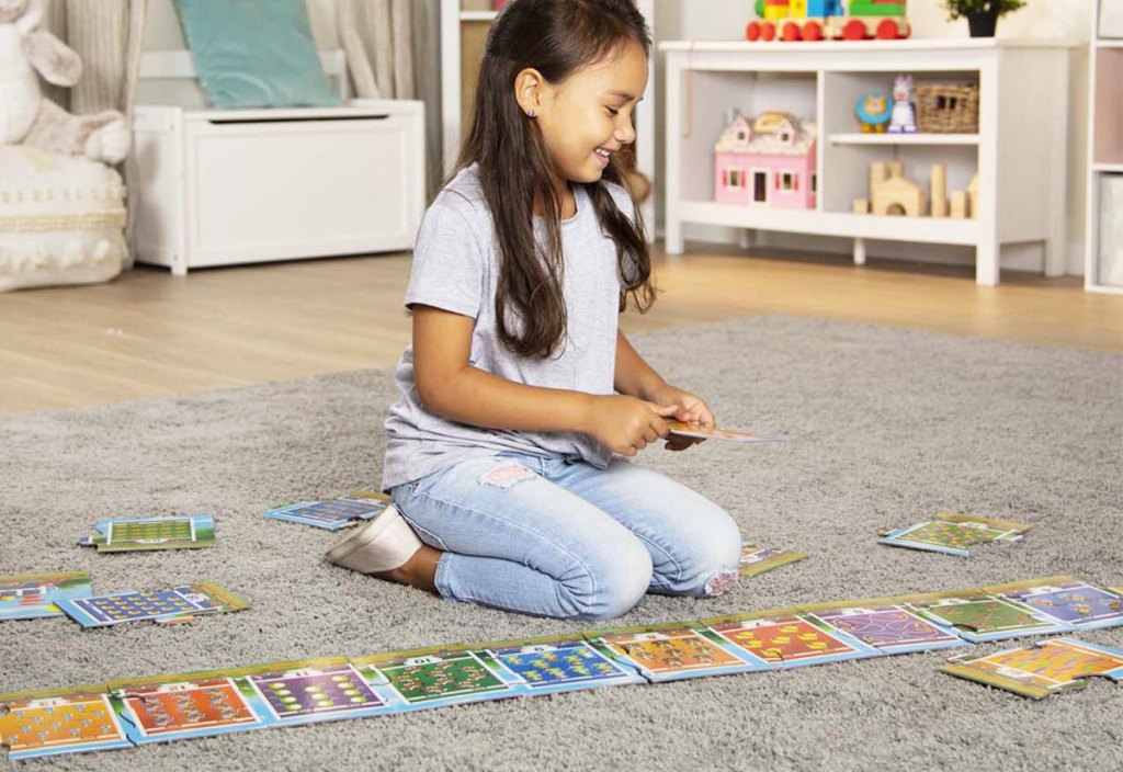 girl playing with floor puzzle