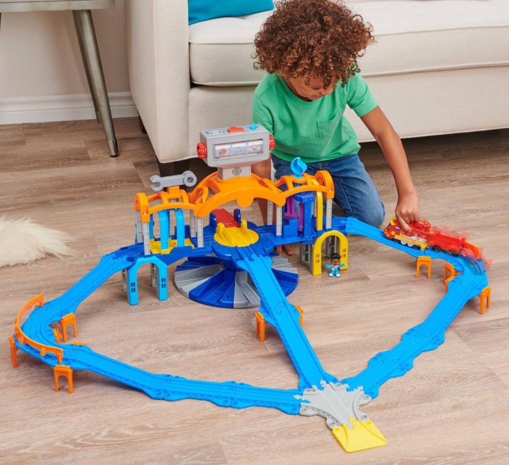 boy playing with a train set