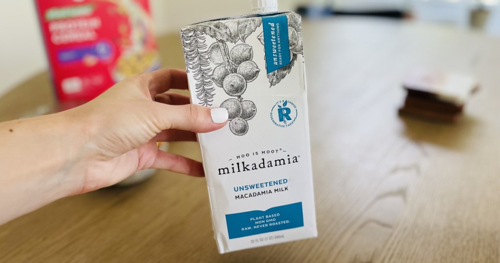 Woman's Hand holding Milkadamia Unsweetened Macadamia Milk