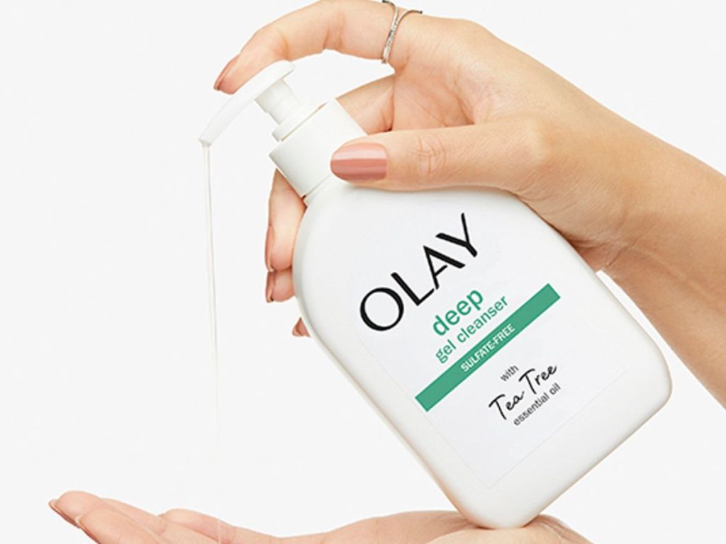Hand dispensing a Olay Deep Gel Cleanser into another hand