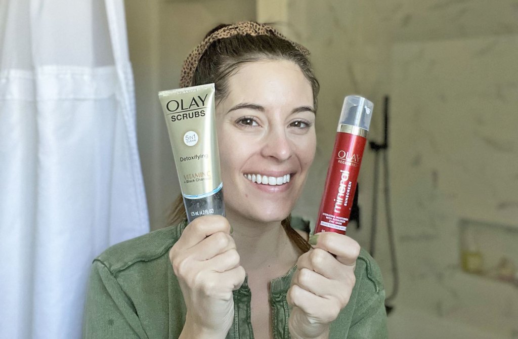 woman holding Olay Detoxifying Face Scrub & Mineral Sunscreen