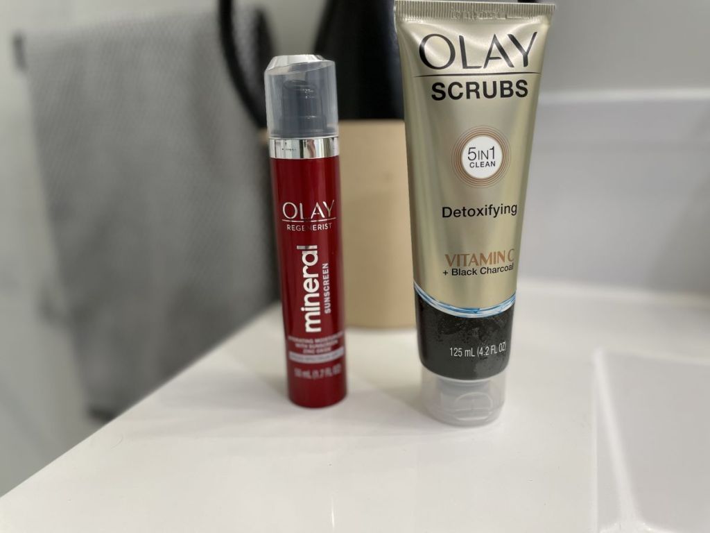 Olay Sunscreen and Face Scrub on a bathroom counter
