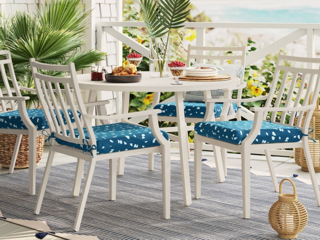 white patio dining set with blue cushions on chairs