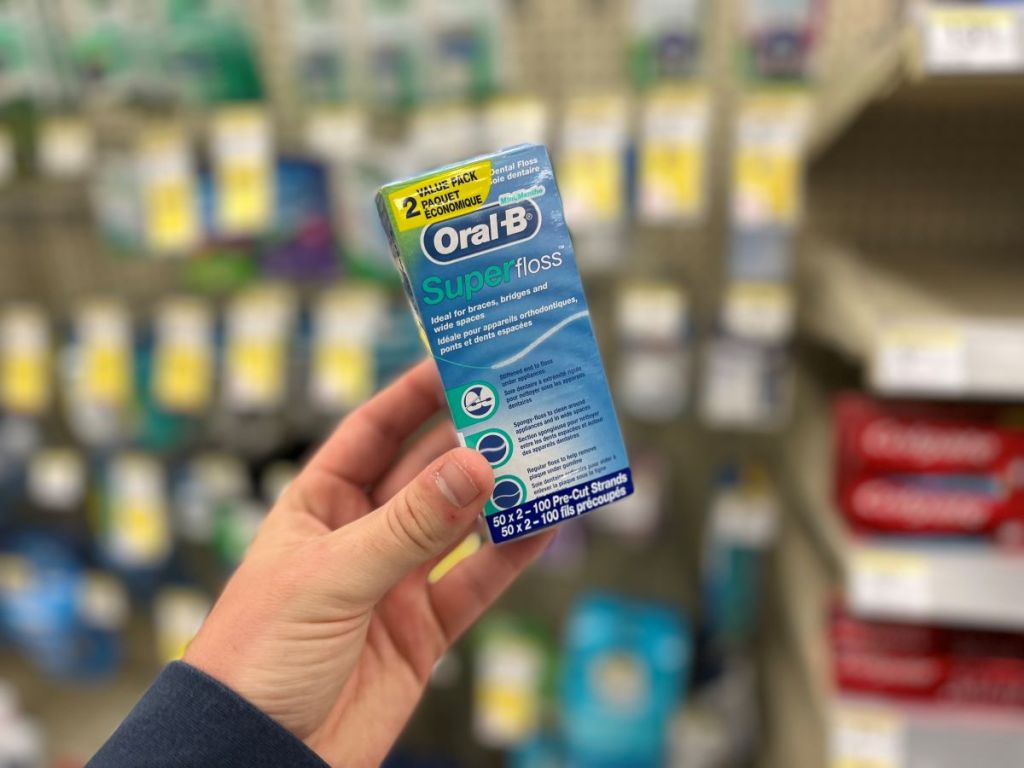 hand holding Oral-B Super Floss