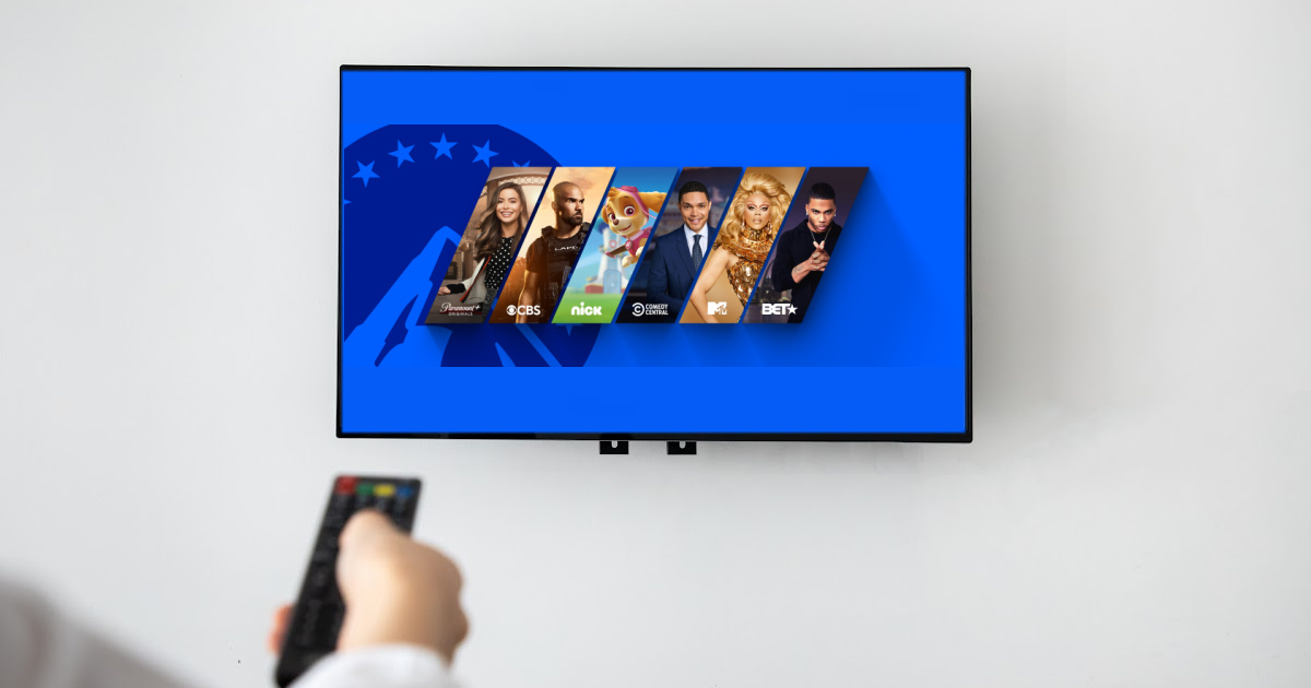 pointing remote at television on wall