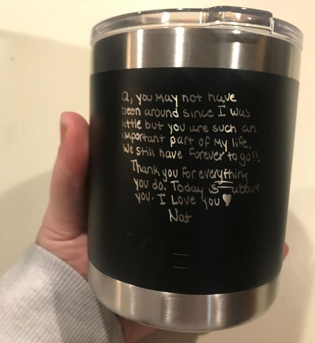 Hand holding a personalized YETI