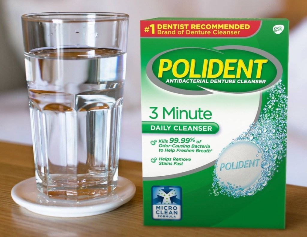 Polident Denture Cleansers box next to a cup of water