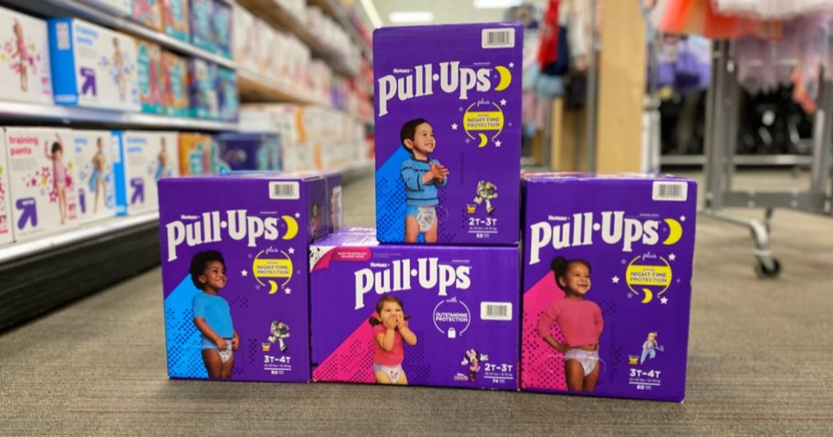 purple boxes of training pants diapers on floor