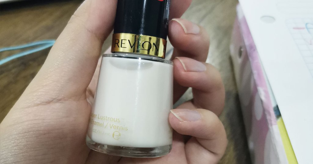 hand holding bottle of revlon nail polish