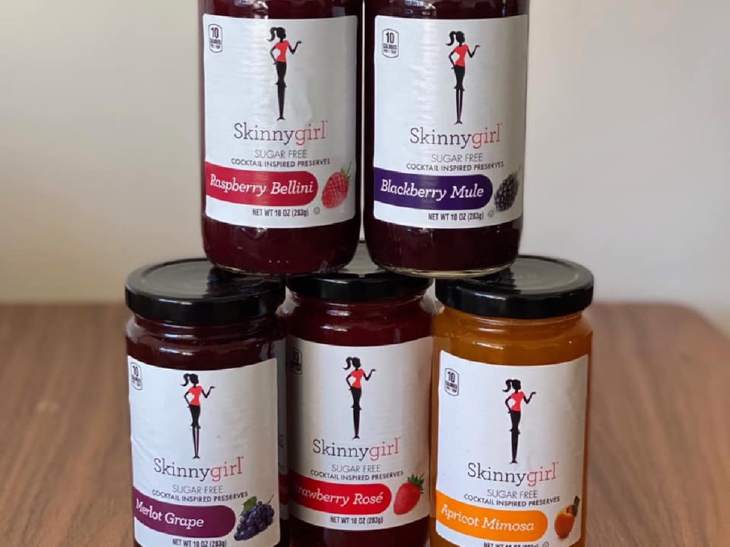 five jars of sugar-free fruit preserves in different flavors on table