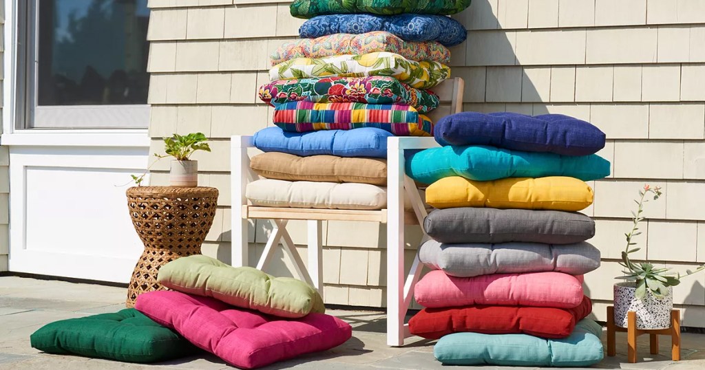 multiple outdoor chair pads stacked on a patio chair