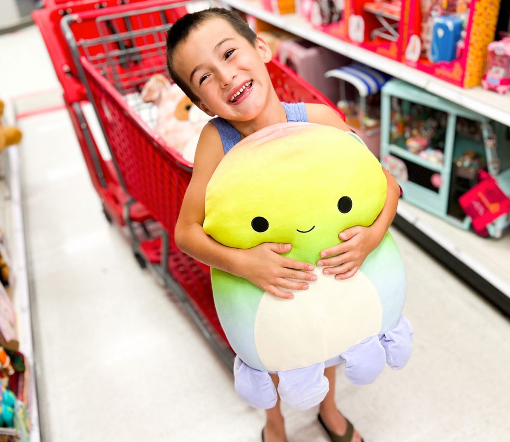 boy holding octopus squishmallow
