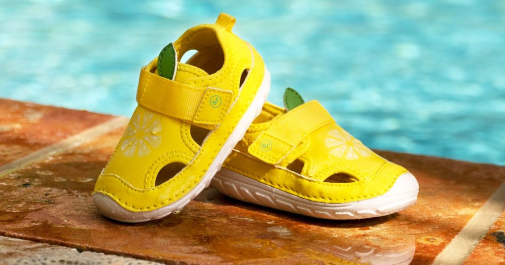 yellow kids water shoes by pool