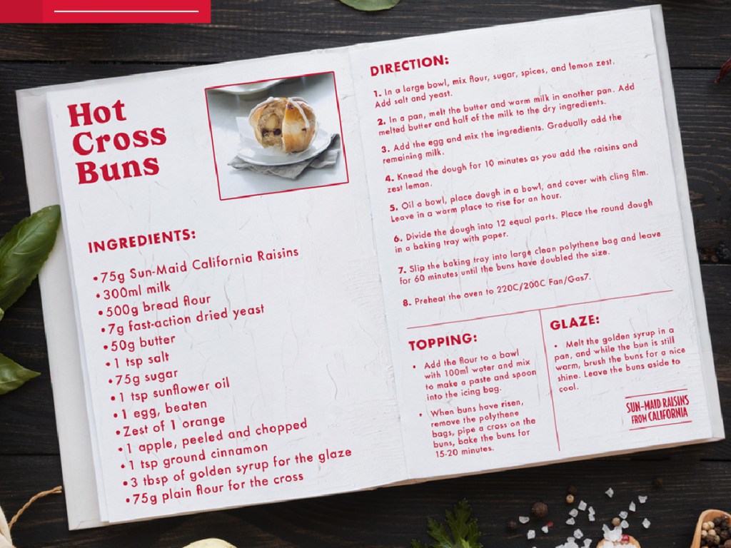 recipe book opened to hot cross buns recipe