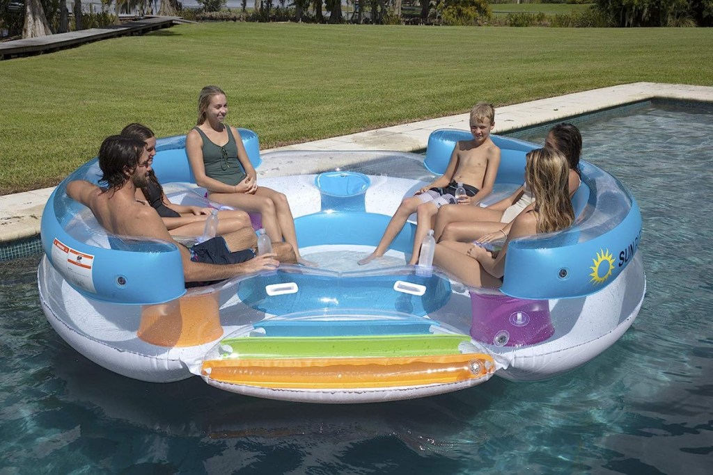 A family sitting on a Sun Pleasure Tropical Tahiti Pool Float