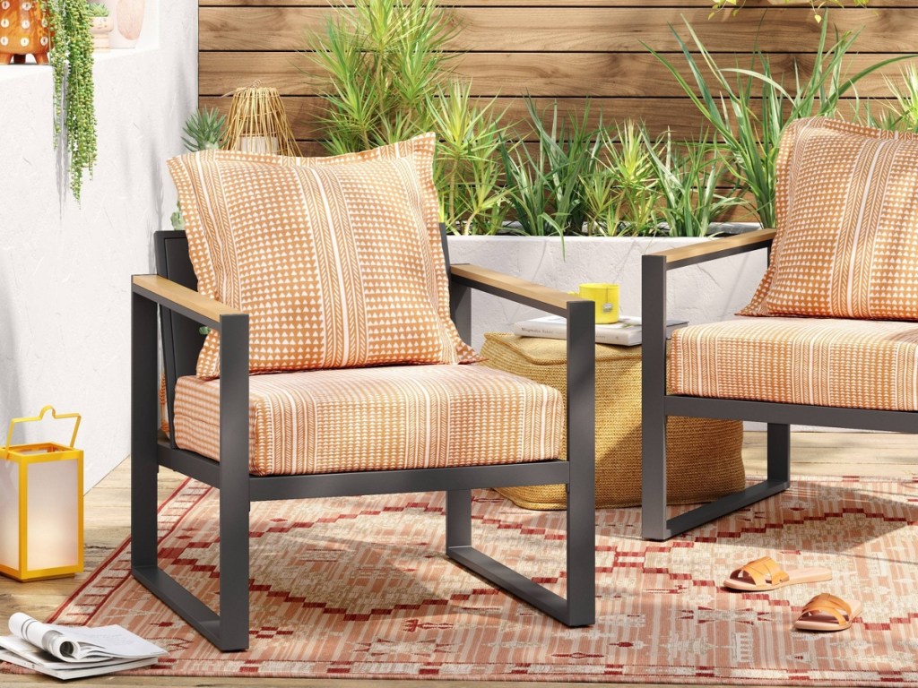 two patio chairs with orange geometric print cushions