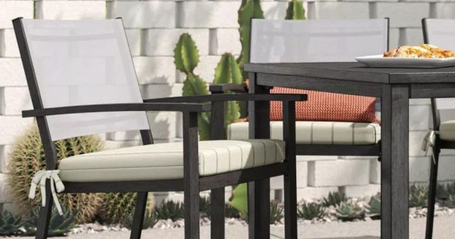 target theshold striped patio seat cushion in black and cream on seat next to patio table
