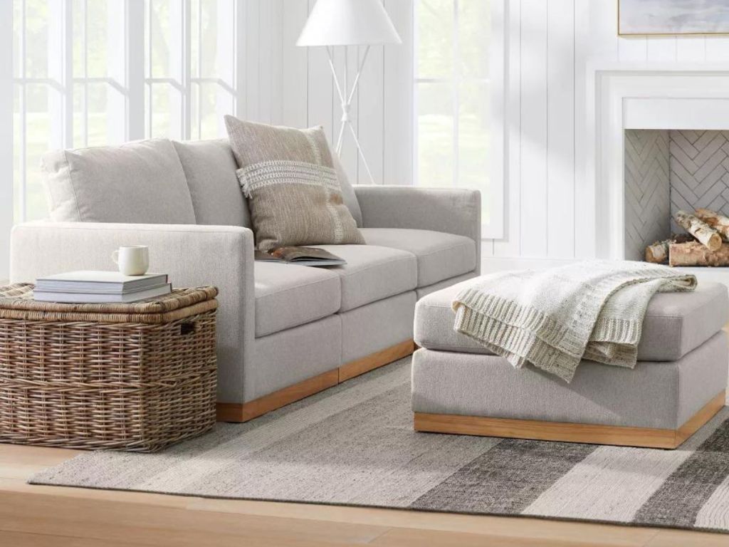 gray and white striped area rug under couch and ottoman in living room