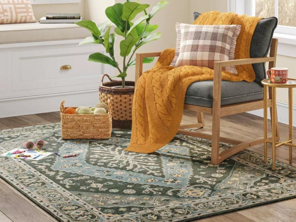 green themed area rug under chair in living room 