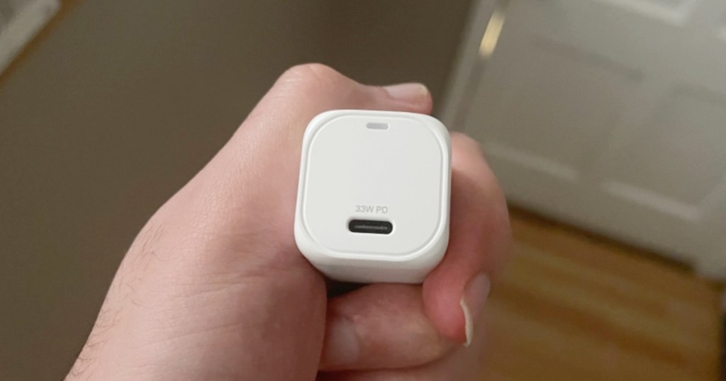 hand holding wall charger piece