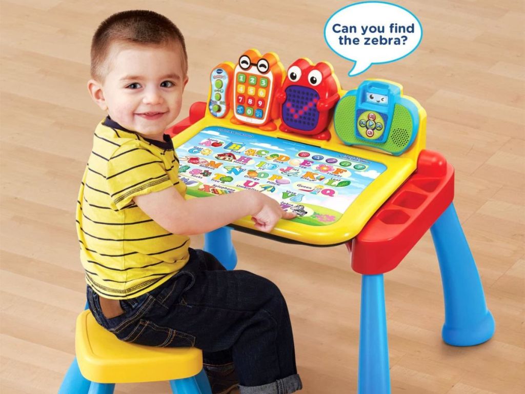 boy playing with an activity desk